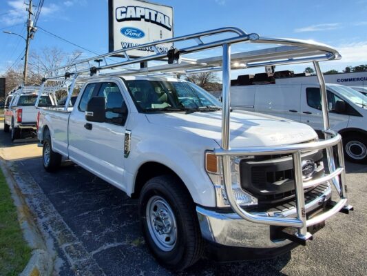 Front angle showing a commercial Ford truck equipped with an over-cab aluminum rack.