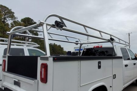Rear-angle view of a Ram Knapheide truck featuring a full aluminum ladder rack over the utility body.