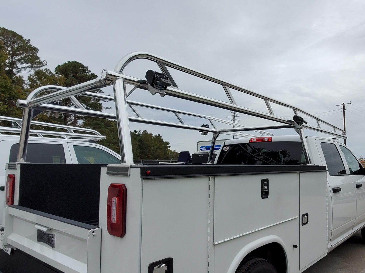 Rear-angle view of a Ram Knapheide truck outfitted with a polished aluminum rack.