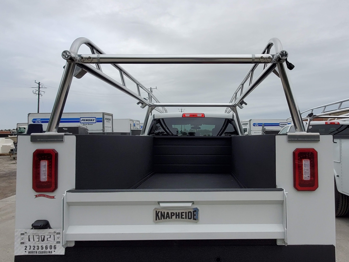 Rear view of a service body truck showing the aluminum rack structure.