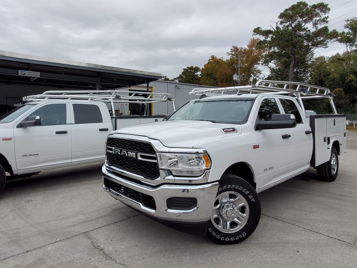 Front angle of a Ram utility truck equipped with a polished aluminum rack.