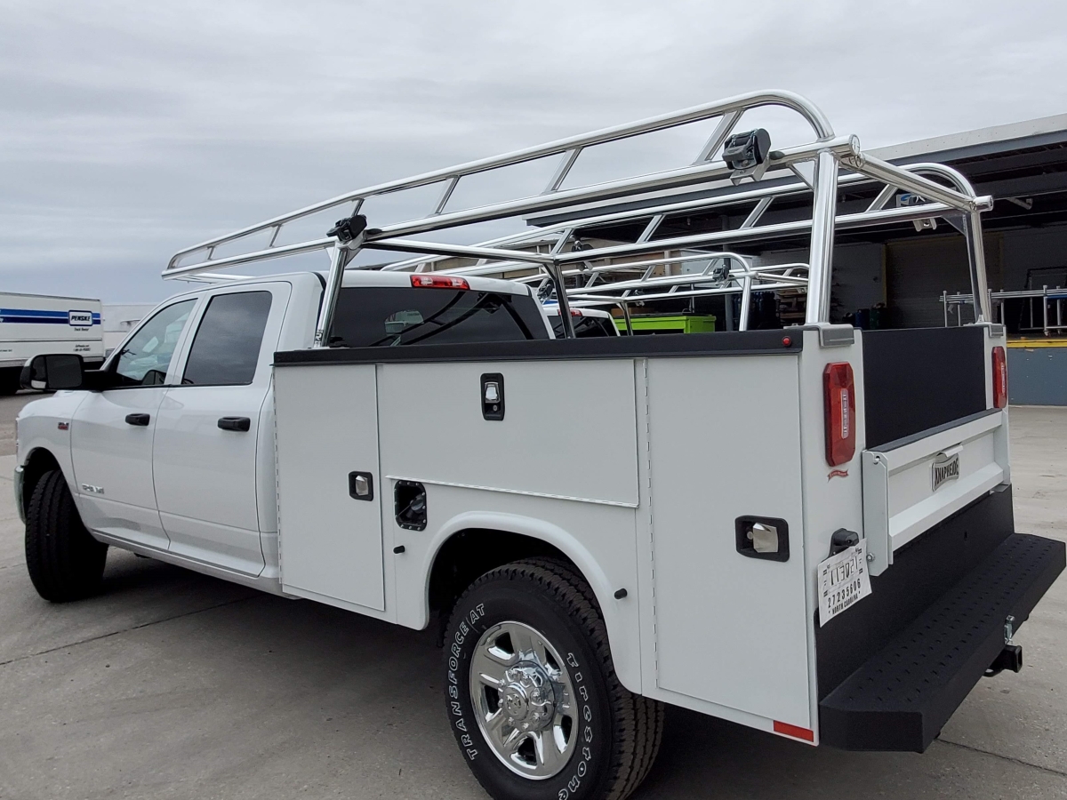 Quarter-angle view of an aluminum rack installed on a Knapheide utility body.