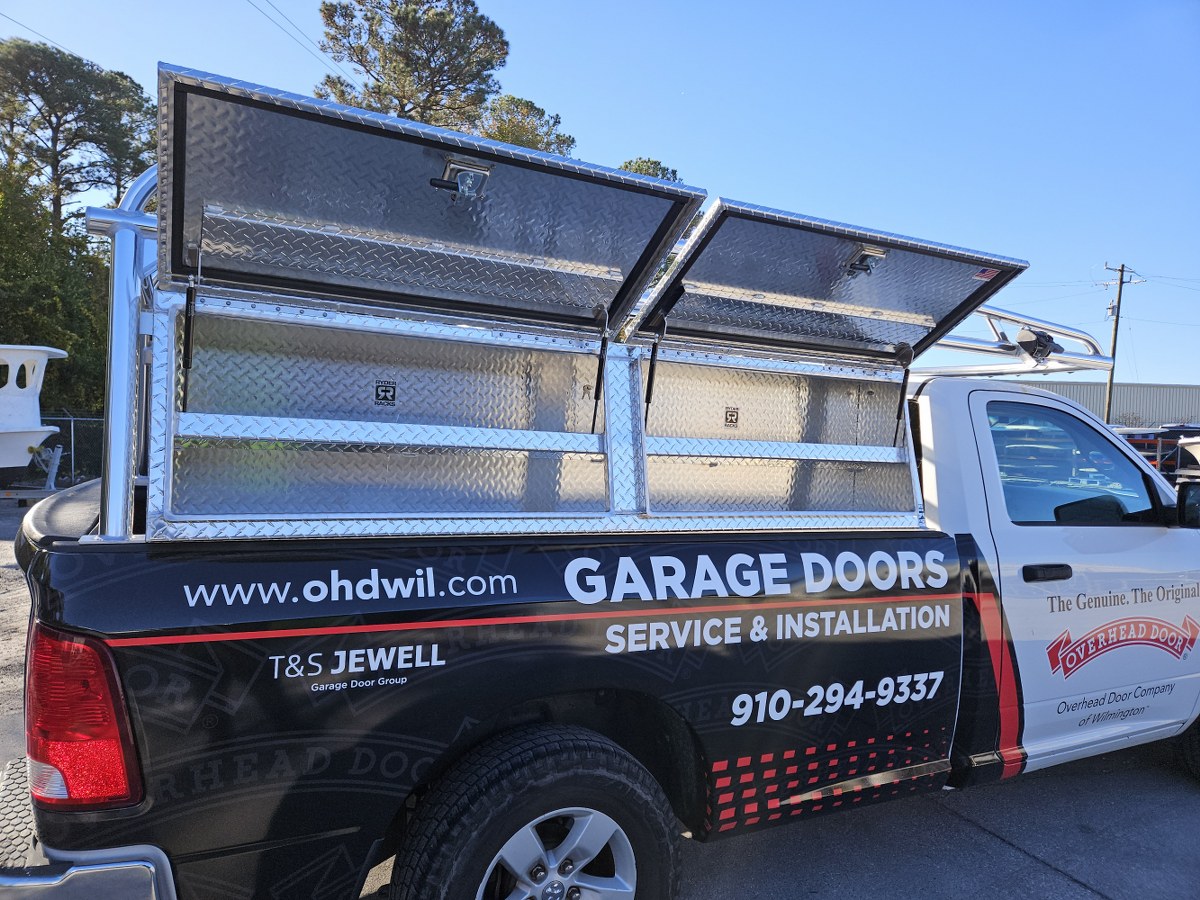Close view of topsider tool boxes mounted under a polished aluminum truck rack.