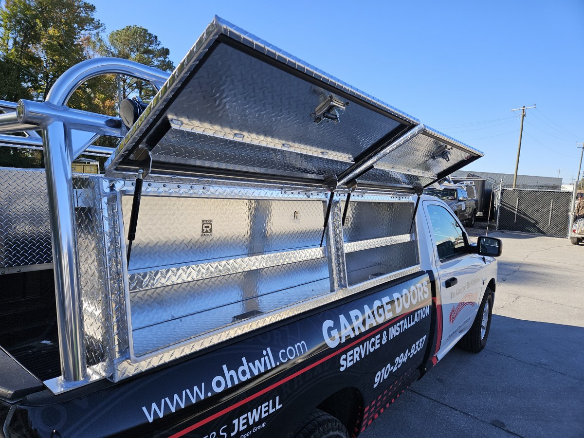 Rear-quarter angle showing the aluminum rack and topsider storage boxes.