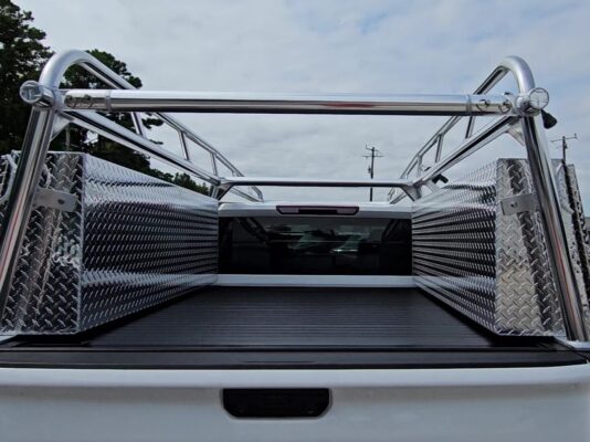 Interior bed view showing the standard topsider tool boxes installed beside the JackRabbit retractable bed cover.