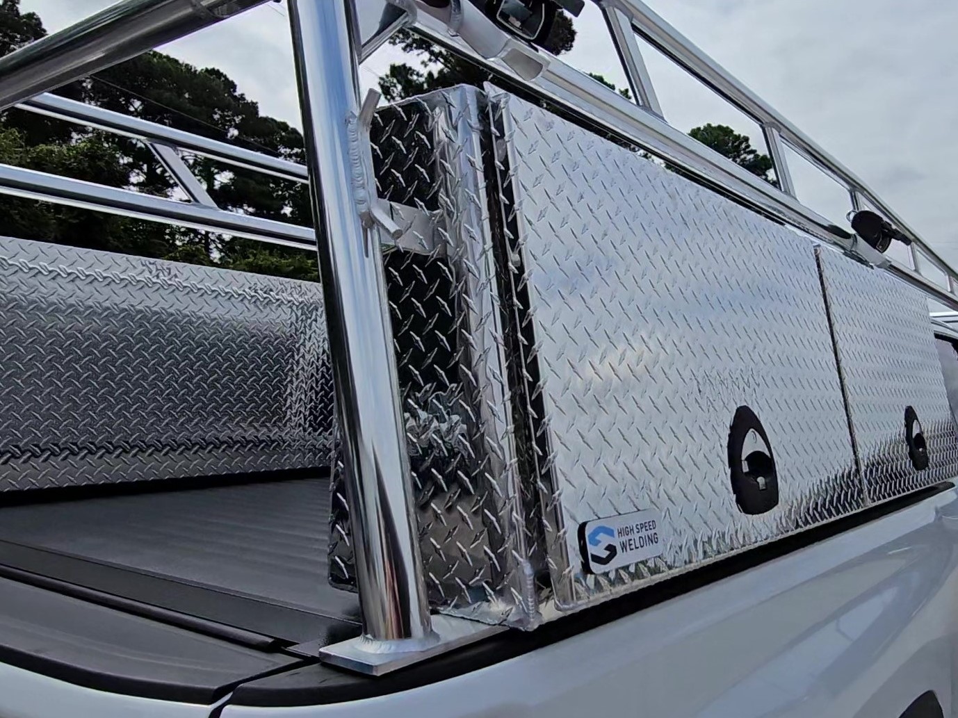 Close-up of the anodized Pro Series rack leg mounted next to the standard topsider tool box.