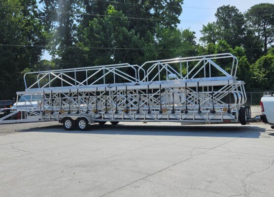 Side view of custom aluminum gangways secured on a trailer for bulk shipment to a dock installation