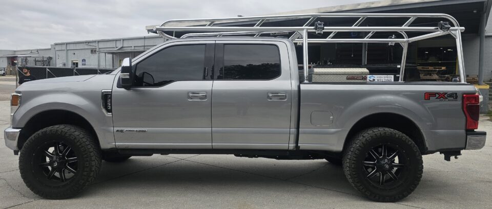 Ford F250 ladder rack with welded rails and a Weather Guard toolbox.