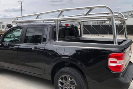 Driver-side view highlighting the curved uprights and multiple crossbars on the aluminum truck