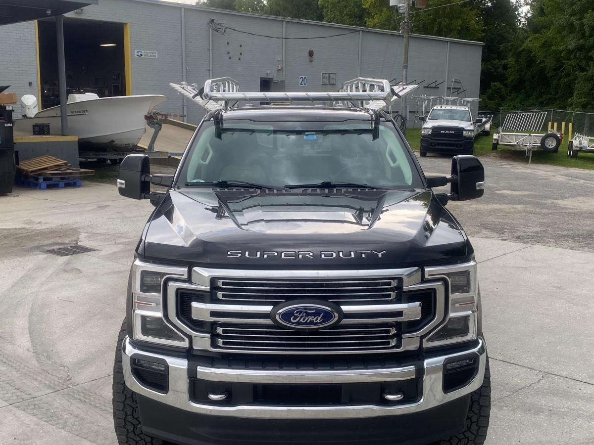 Head-on front view of a Ford F-250 Super Duty equipped with Ryder Rack WELD and Topsider combo installed by High Speed Welding.