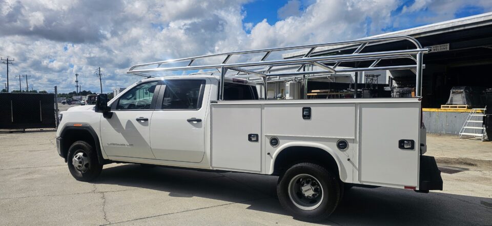 Rear bed area showing the ladder rack structure mounted above the Knapheide service body on a GMC Sierra HD.