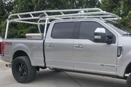 Side view of the welded Ryder Rack WELD ladder rack mounted on a Ford F250 Super Duty with an aluminum toolbox.