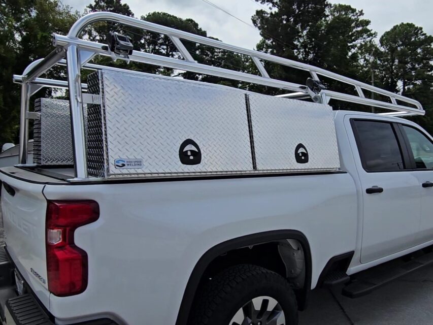 Passenger-side view of the anodized Ryder Rack Pro Series setup with standard topsider tool boxes on a Chevy 2500 HD.