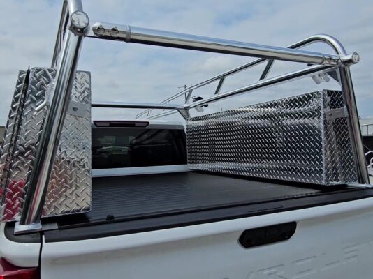 Rear corner view highlighting the welded anodized Pro Series rack above the diamond-plate topsider tool box.