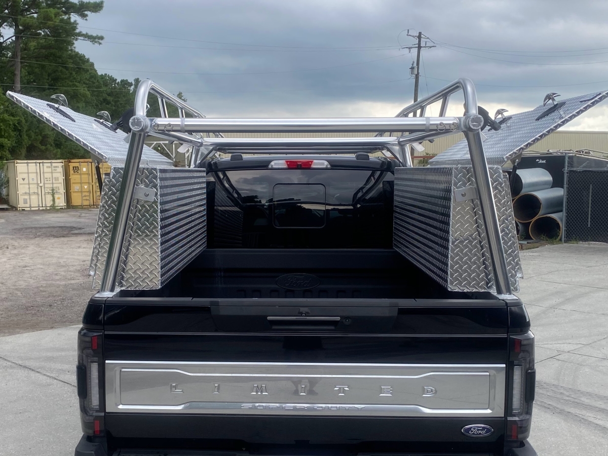 Rear view of a Ford F-250 Super Duty with aluminum Ryder Rack WELD and Topsider boxes open for storage access.