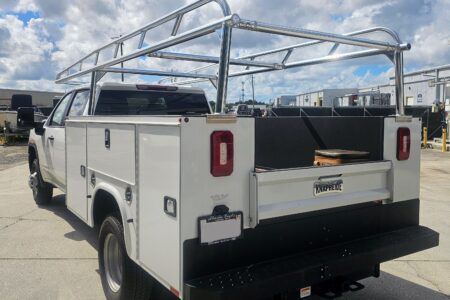 Polished aluminum Ryder Rack Service Series installed on a Knapheide service body, rear-angle view on a GMC Sierra HD.