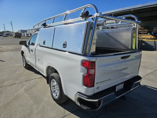 Rear angle of pickup with removable rear bar and rack straps mounted on ladder rack