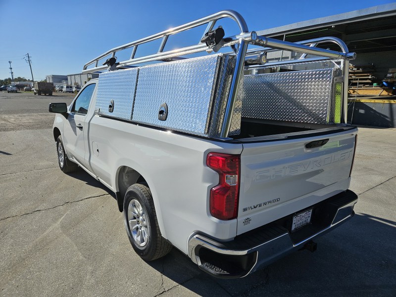 Rear angle of pickup with removable rear bar and rack straps mounted on ladder rack