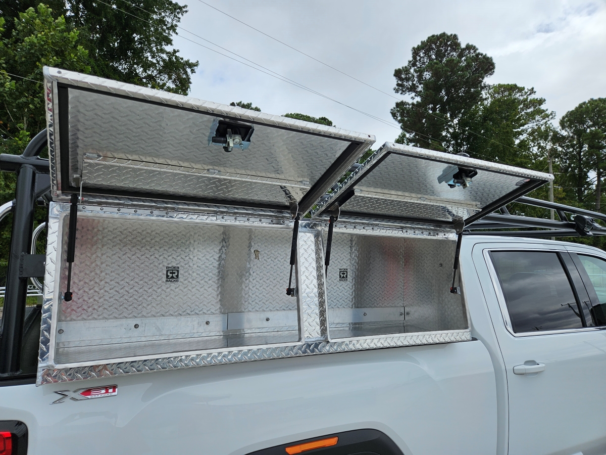 Open XL topsider tool boxes under a ladder rack with tool boxes on a GMC Sierra.