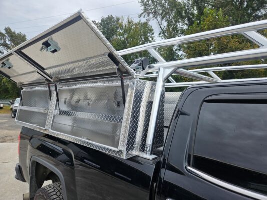 Open topsider toolbox showing interior on black pickup.