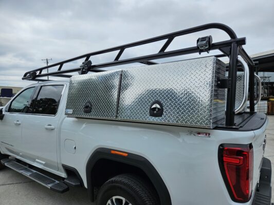 Side view showing XL aluminum topsider tool boxes mounted low on the truck.